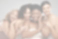 Four women standing side by side, smiling at the camera