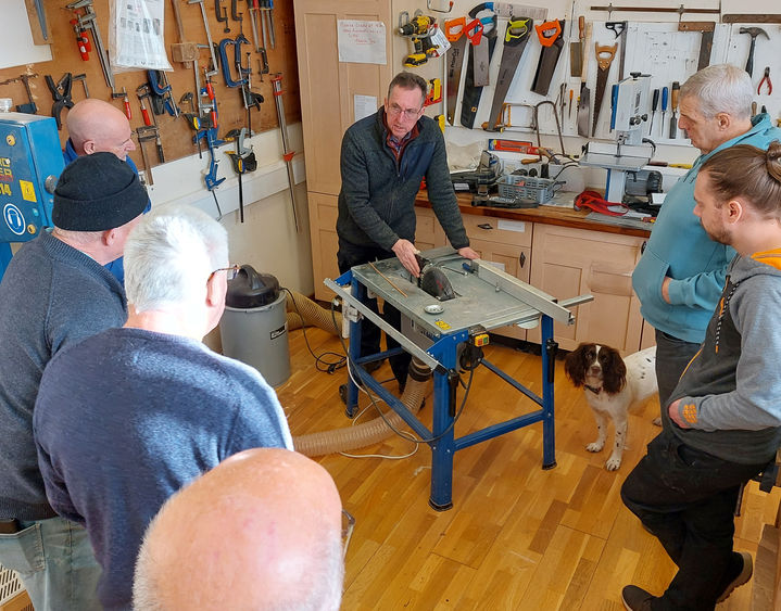 Several members in the workshop learning safe machine use