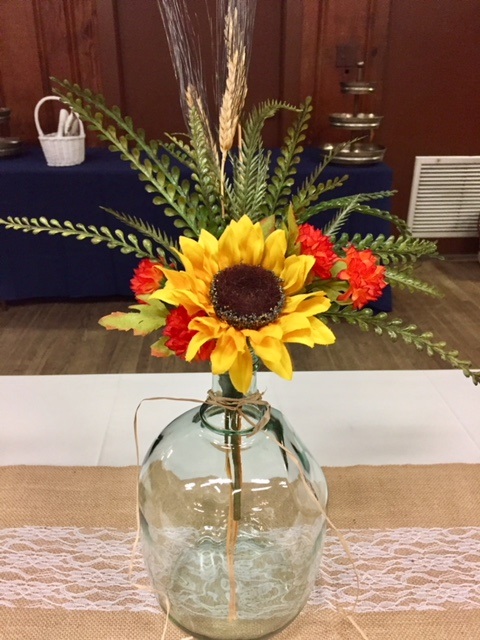 fall flowers in wine jug