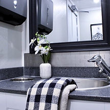 Interior look at the sink and mirror of a luxury restroom trailer rental in Armada Michigan