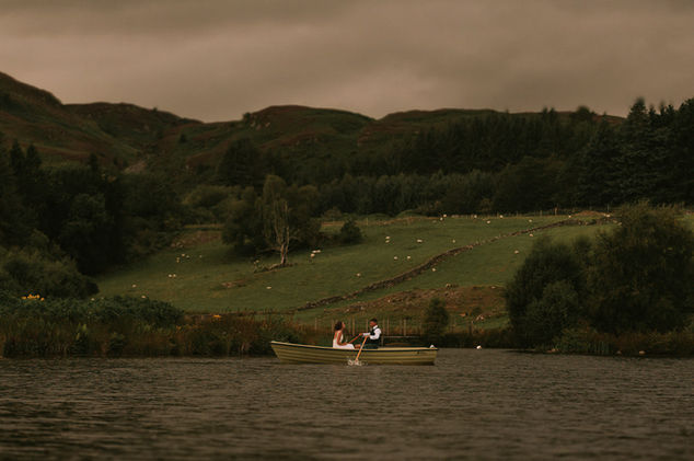 couple in a boat surrounded by scenic Scottish countryside during a wedding at Cardney Steading