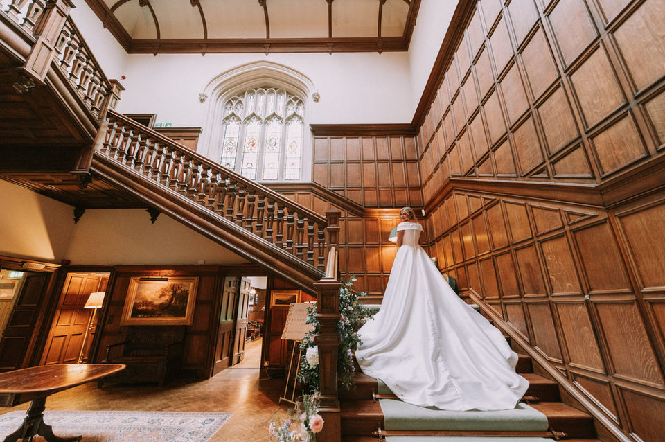 bride walking down a wooden staircase inside a Scottish wedding venue Dundas Castle