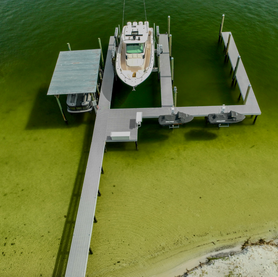Aerial view of a boat dock with several boat lifts.