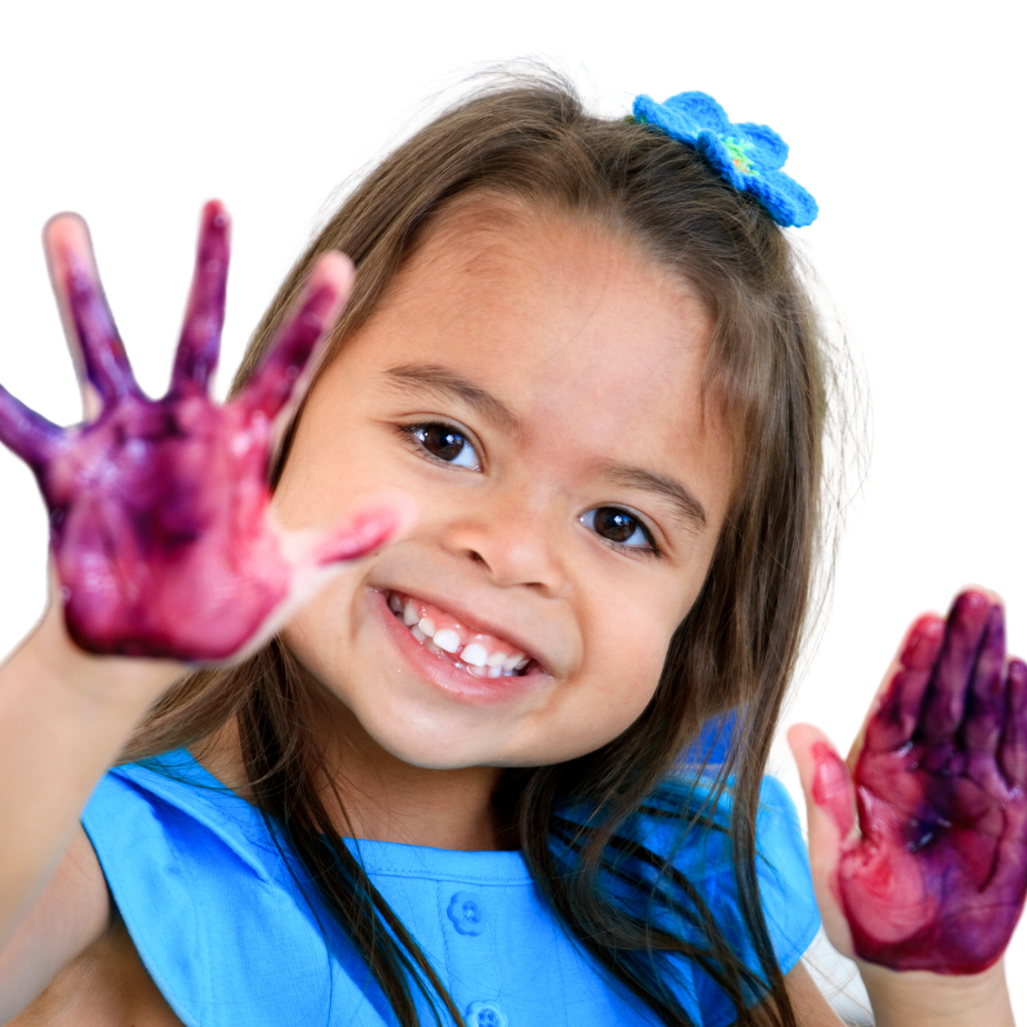 smiling child with bow in hair and paint on hands