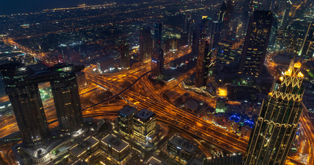 Dubai skyline at night with illuminated highways and skyscrapers in Downtown Dubai, United Arab Emirates