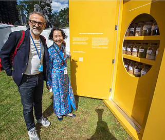 Two people open the cabinet for Goal 2, zero hunger