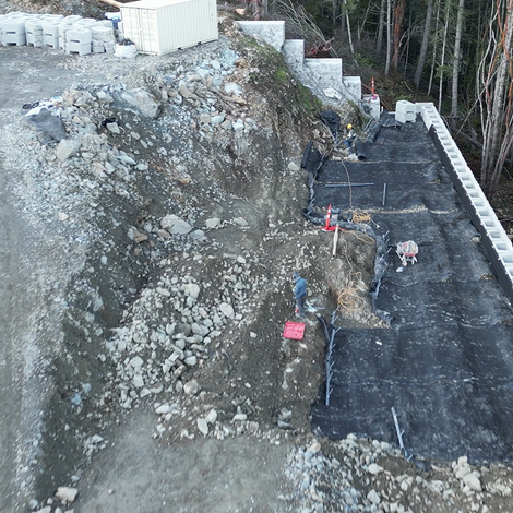 Installing geogrid and anchors