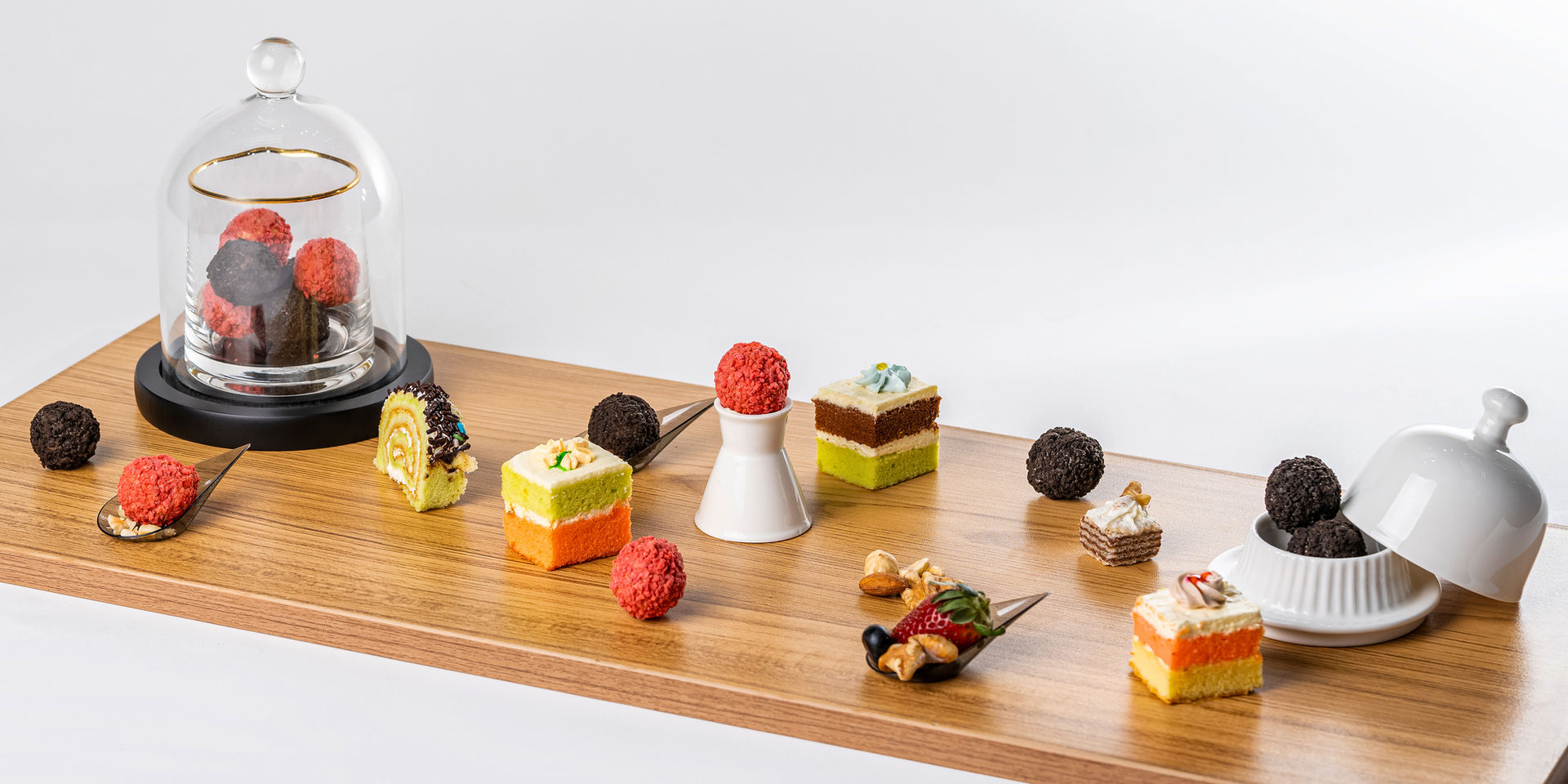 A table full of Mr. Kun's Lava Cookie Balls and other types of cakes.