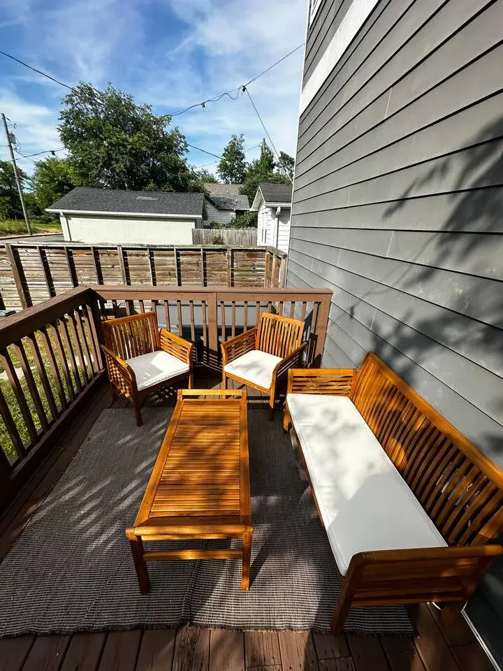 Elevated modern deck with outdoor seating and wooded ridge views at Nashville area property