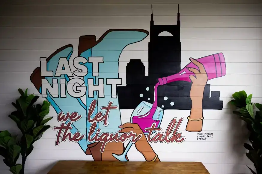 Urban mural art with party aesthetic text and city skyline in Nashville bachelorette house entertainment space