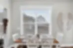 Modern dining room at Nashville TN restaurant with wooden table, contemporary place settings, and natural light from windows