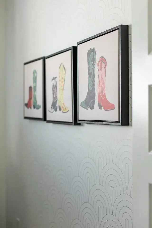 Colorful framed cowboy boot artwork gallery display on white wall in Nashville vacation rental