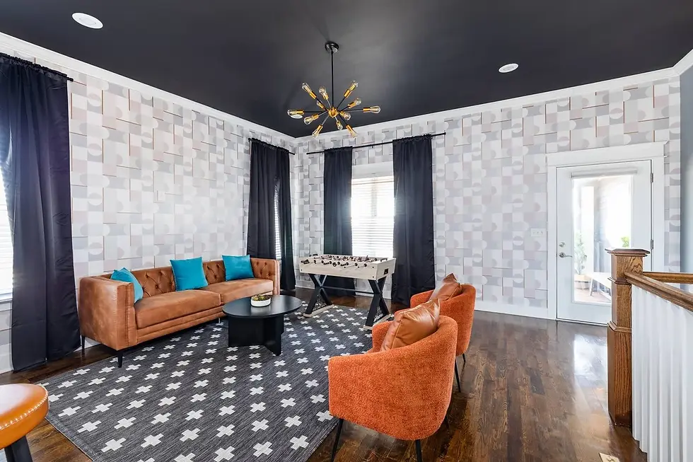 Modern recreation room with leather sofa and foosball table in Nashville vacation rental