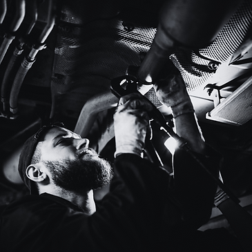 man underneath car fixing