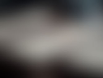 Printed decision-rights and operating-cadence frameworks laid out on a conference table in an executive meeting room.