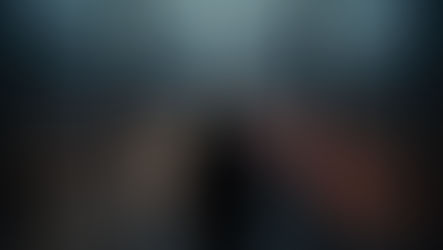 Silhouette of a business executive standing alone at floor-to-ceiling office windows at dusk, overlooking a city skyline with blurred streaks of traffic light below — capturing the tension between stillness and speed in high-stakes decision-making.