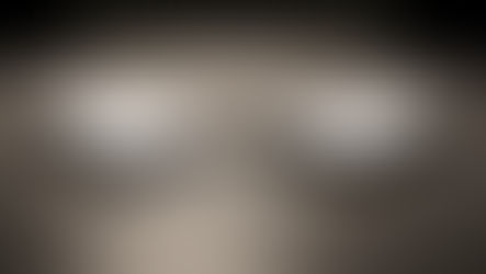 Two documents on a boardroom table—a strategy deck and a decision-rules binder—with a pen between them, symbolizing strategy execution and decision rights.