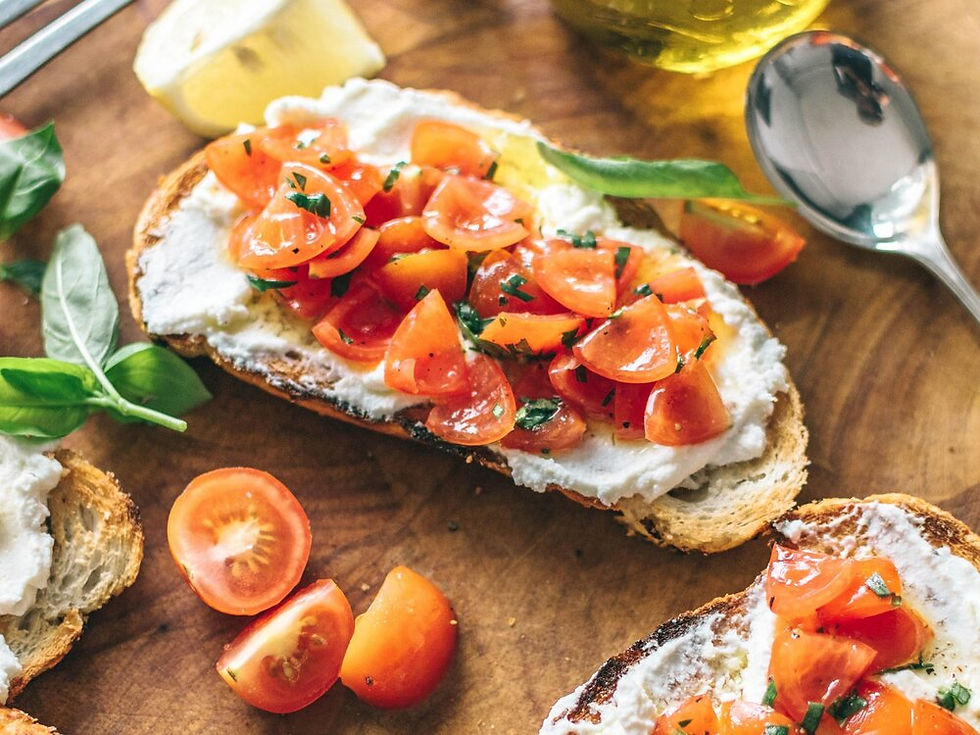 Bruschetta topped with tomatoes, goat cheese, basil, and olive oil