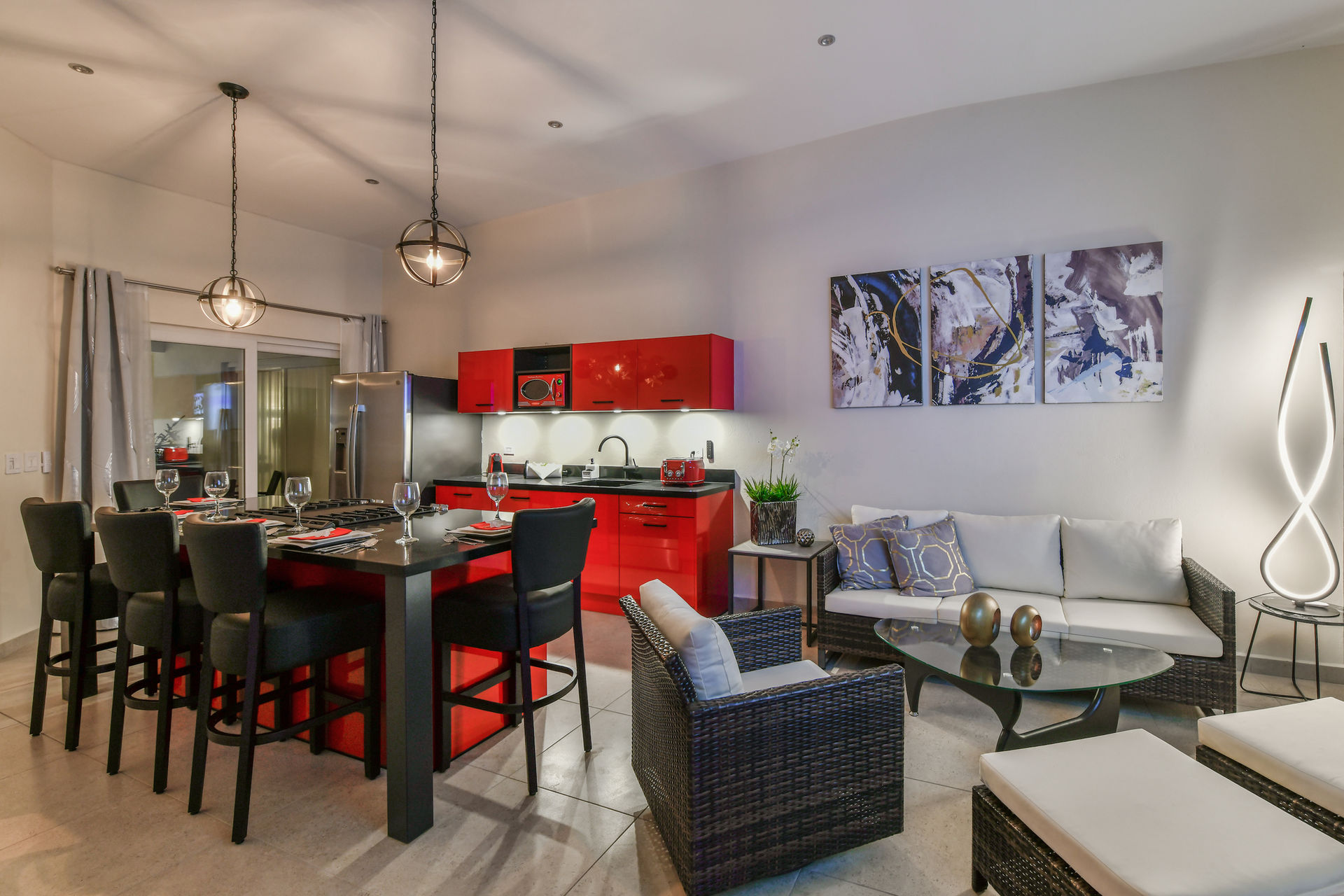 Big and open living room area with plenty space. TV, sound system, lightening setting and swimming pool view