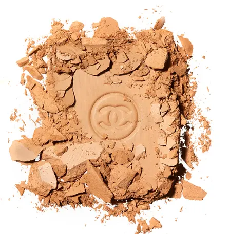 Broken cosmetic powder photographed for luxury beauty and makeup advertising campaign
