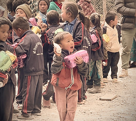 Many small children receiving food packages