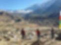 Team in front big mountain view with a village in the valley