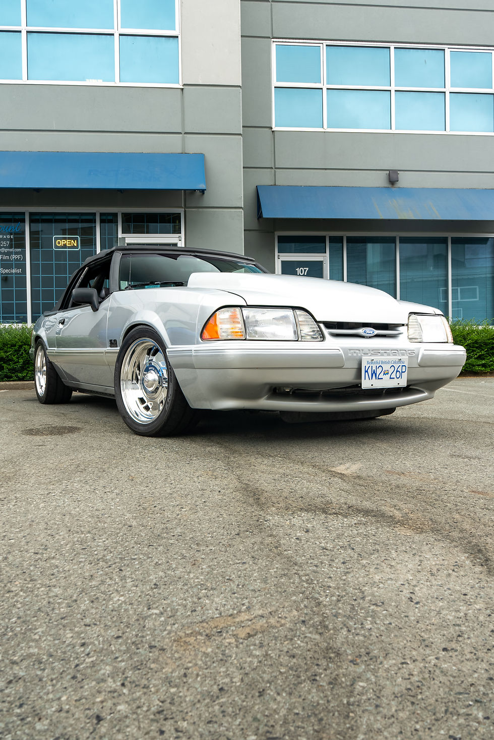 Silver Ford Mustang with paramount detail gar outside building