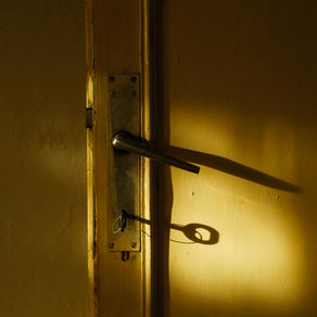A key unlocking a glowing door, symbolizing internal freedom and choice.