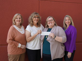 Young Ladies Grand Institute makes donation to Superintendent of Schools
