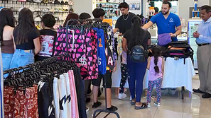 Shoe store hosts backpack giveaway