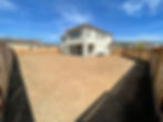 the original yard is empty and looks like a dirt lot. this view looks back toward the home from the Morgan hill property's back corner