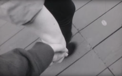 Thief and young woman holding hands.