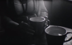 Thief and young woman have coffee.