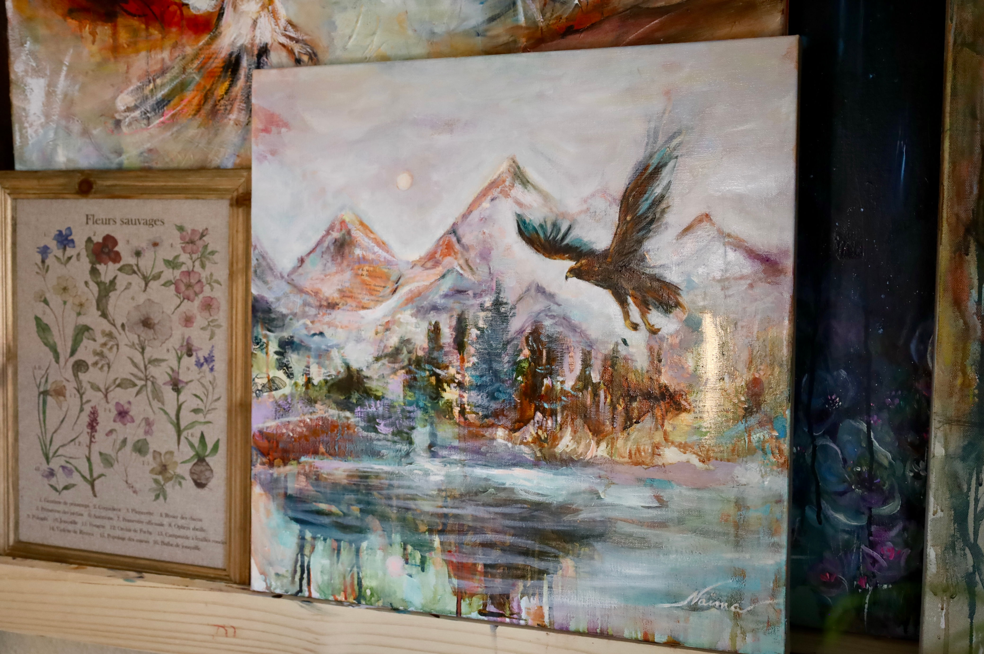 Oil painting "Where Earth Meets Eternity" showing Tetons mountains with a soaring eagle and golden butterflies in warm ethere