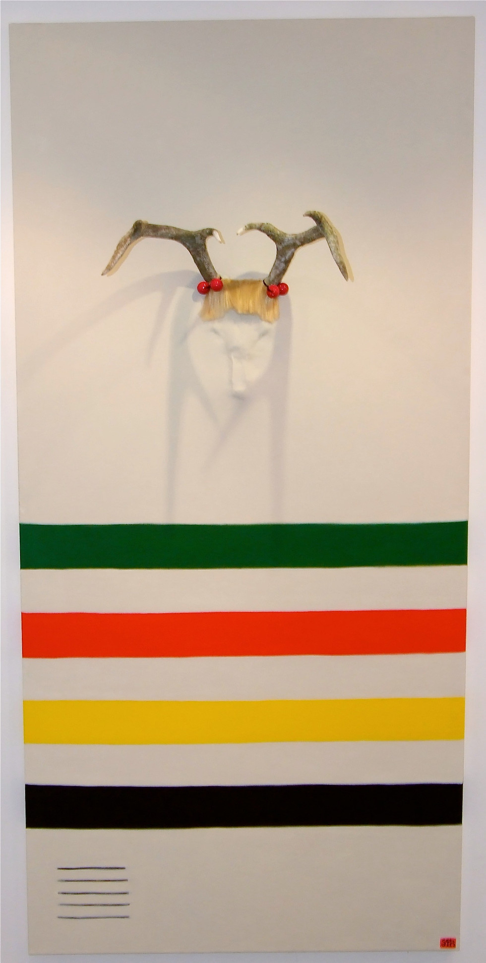 Painting of a Hudson's Bay blanket with deer antlers protruding out and a fringe of blonde doll hair with pig-tail baubles.