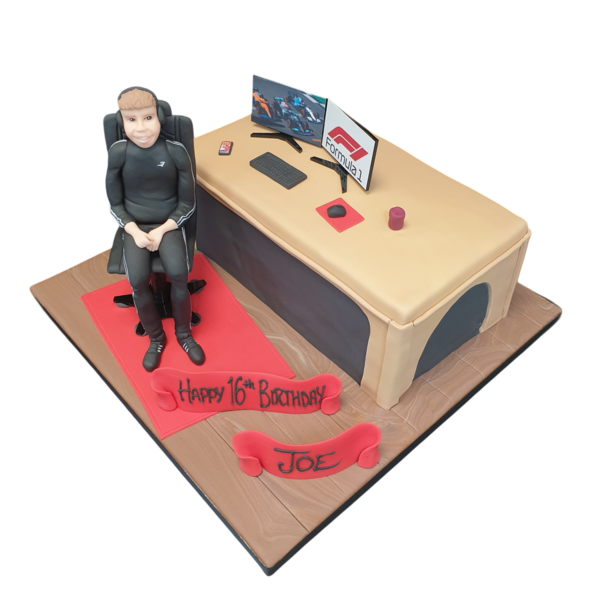 Chocolate cake decorated with fondant inspired by a tech-savvy gamer boy at a desk, perfect for gaming enthusiasts.