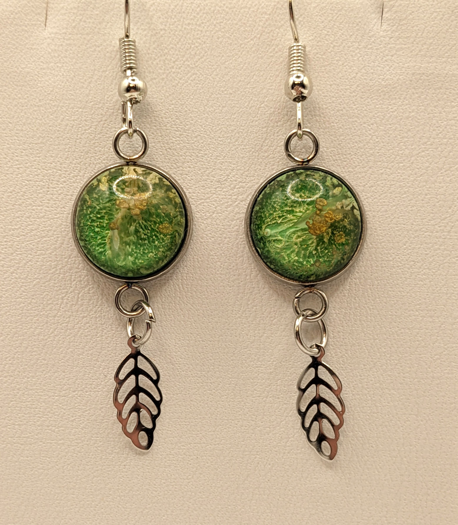 Lovely green and gold earring with feather charm