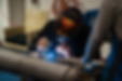 man-working-with-argon-welding-machine-garage-min.jpg