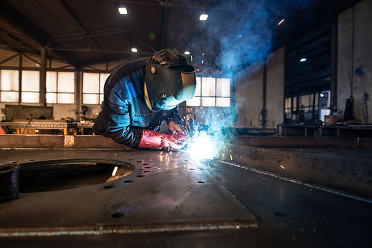 professional-industrial-welder-welding-metal-parts-metalworking-factory.jpg