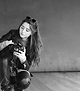 The photographer Manuela kneening down cheching her camera. Black and white image.