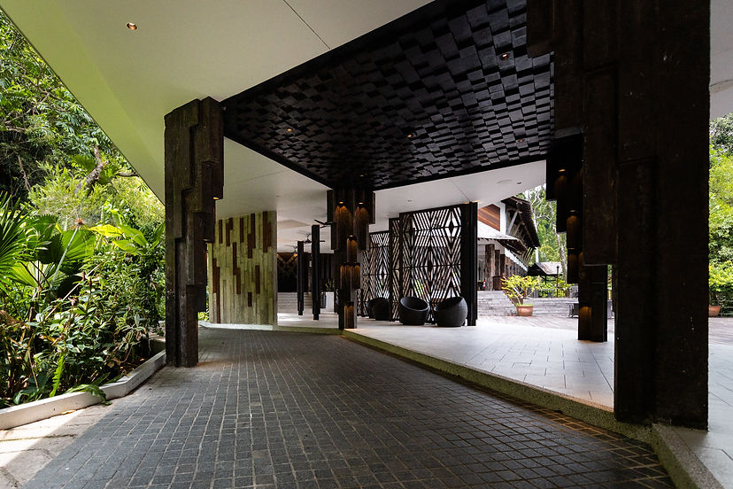 Ceiling view of the drop-off pavilion, showcasing intricate Sabahan batik-inspired patterns integrated into the roofline.