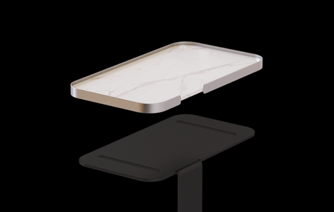 White marble rectangular tray with metallic edges on black background.