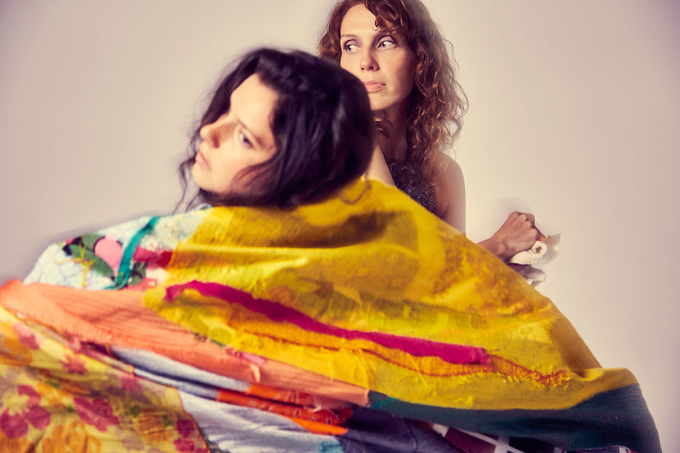 Dancers from The Moving Architects draped in vibrant fabric.