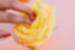 woman's fingers gently touch the inside of a rose