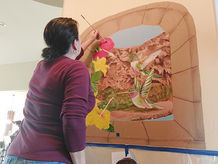 Indoor mural of Havasupai Falls hummingbirds hibiscus flowers brick window