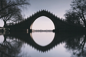 Bridge over water with distinct shadow reflection