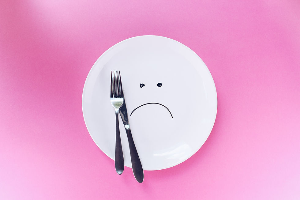 a sad face drawn on an empty plate