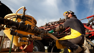 farmer mixing agrochemicals for spray application