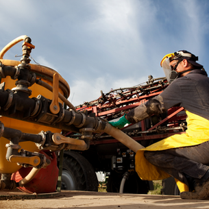 farmer mixing agrochemicals for spray application
