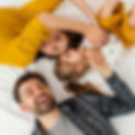 medium-shot-parents-kid-bed-top-view.jpg